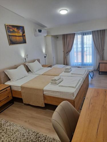 a hotel room with two beds in a room at SADI Hotel in Yakkasaray