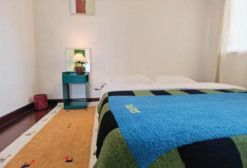 a bedroom with a bed with a blue blanket at M Panda Tower Boutique Chengdu in Chengdu