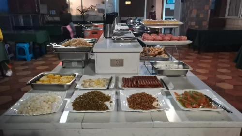a buffet line with many different types of food at Guilin Green Bamboo Hotel in Guilin