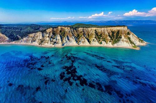 an aerial view of a rocky island in the ocean at Boulitos 1 in Kavos