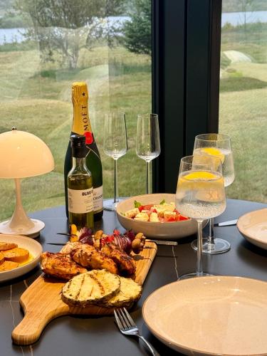 a table with plates of food and glasses of wine at Nest Retreat Iceland in Hella