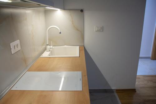 a bathroom with a sink and a faucet at Panorama Tornik Zlatibor P4 apartman in Zlatibor