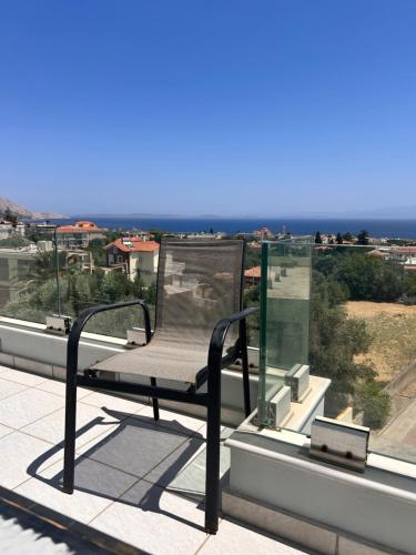 a chair sitting on top of a roof at Latomi Sea View in Chios