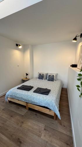 a bedroom with a bed in a white room at Escapade à 2 pas de la Loire in Sandillon