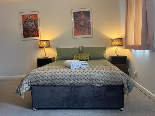 a bedroom with a bed with two towels on it at Stay Still Indian Court in Dalston