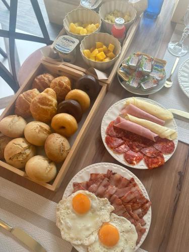 a table topped with plates of breakfast food on a table at La Quinta Luxury Palace in Arnuero