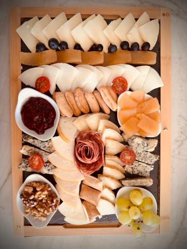 a tray of different types of cheese and other foods at La Quinta Luxury Palace in Arnuero