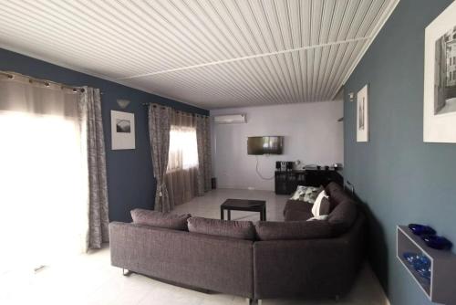 a living room with a couch and a ceiling at Larnaca Breeze in Pyla