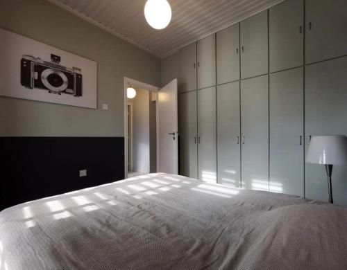 a bedroom with a bed and a camera on the wall at Larnaca Breeze in Pyla