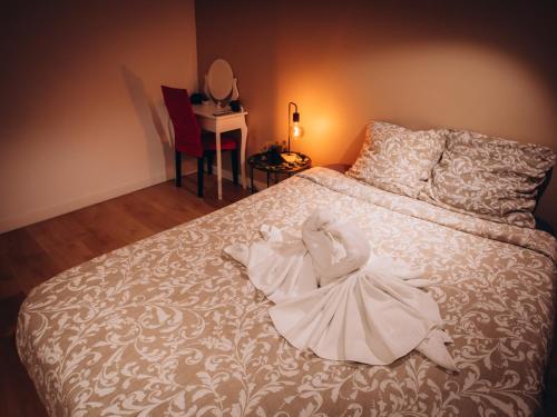 a bedroom with a bed with a dress on it at Casa Di Vibes - Jacuzzi - Sauna in Saint-Maur-des-Fossés