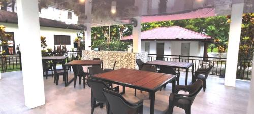 a group of tables and chairs on a patio at Casa G Private BeachfrontYour own private beach in Samal