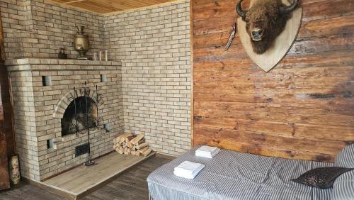 a room with a brick wall with a fireplace at Green Hills Villa in Sakhnovka