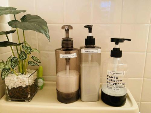 two bottles of soap on a shelf in a bathroom at The Abe Ikebukuro in Tokyo