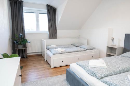 a bedroom with two beds and a window at Vyskoč na hory in Nová Lesná