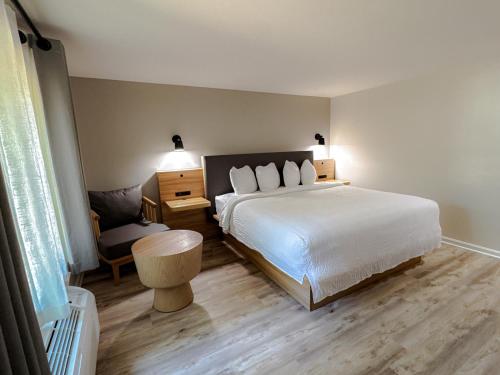 a bedroom with a bed and a desk and a chair at The Earl of Sandwich Motel in East Sandwich