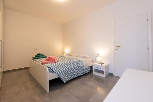 a small bedroom with a bed and a night stand at Casa Gigi in Vercana