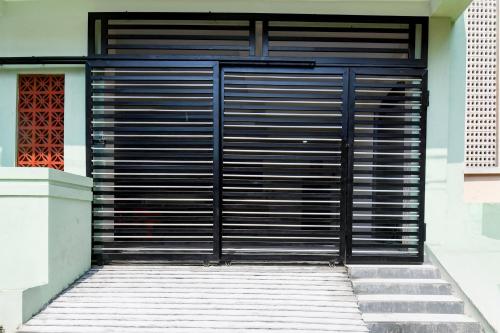 a black metal garage door on a building at Super Collection O VIP Road Near Golden Beach in Puri
