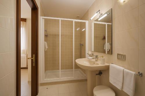 a bathroom with a sink and a shower at Elara MSuites in Viveiro