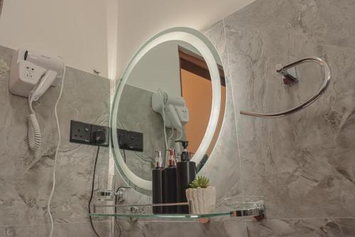 a bathroom with a mirror and a sink at Ambula Resort in Nuwara Eliya