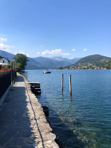 a view of a lake with a boat in the water at Penthouse Orta Imagine the Lake in Orta San Giulio