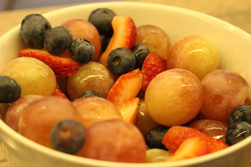 a bowl filled with fruit and vegetables on a table at Faz Hostel Boutique in Cordoba