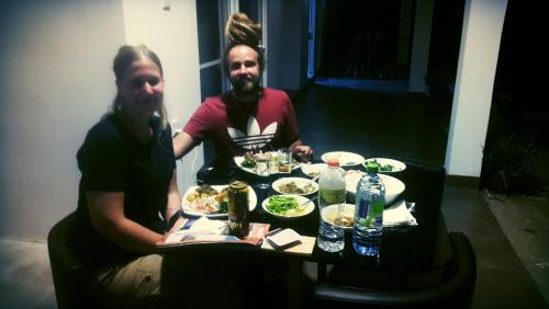 two men sitting at a table with plates of food at Ella Rock Land in Ella