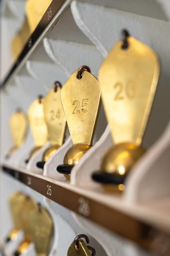 a row of gold spoons on display in a store at Le Flaubert in Trouville-sur-Mer