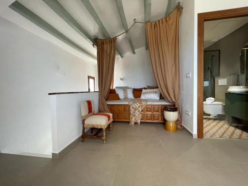 a bedroom with a bed and a chair in a room at H&B COSTABLANCA in Villajoyosa