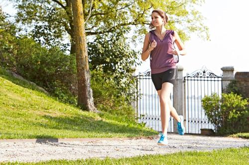a woman running on a path in a park at San Clemente Palace Venice in Venice