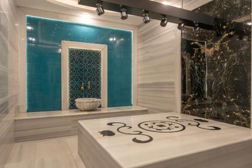 a room with a table with a mirror on the wall at Uliv Apart Hotel & SPA in Ayvalık