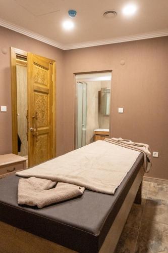 a bed in a room with a large mirror at Uliv Apart Hotel & SPA in Ayvalık