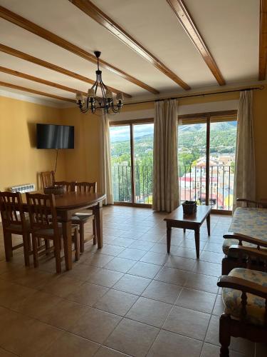 a living room with a table and a dining room at Apartamentos Cuesta de la Cruz in Caravaca de la Cruz