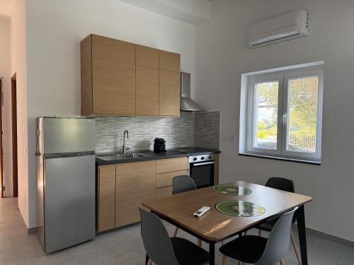 a kitchen with a table and a refrigerator at Casa Marina in Villammare