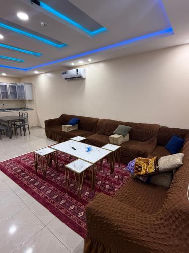 a living room with a couch and tables on a rug at شاليهات زارا Zare in Taif