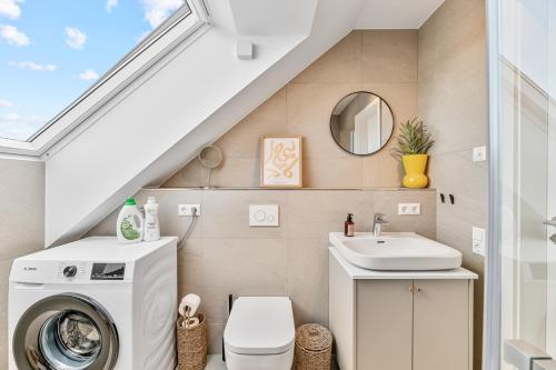 a bathroom with a washing machine and a sink at WHONAP - BLUVYN I Business I Parkplatz I Balkon I Natur in Walldürn