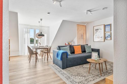 a living room with a blue couch and a table at WHONAP - BLUVYN I Business I Parkplatz I Balkon I Natur in Walldürn