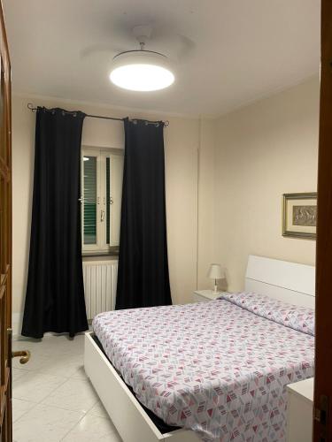 a bedroom with a large bed with black curtains at House Volla in Volla