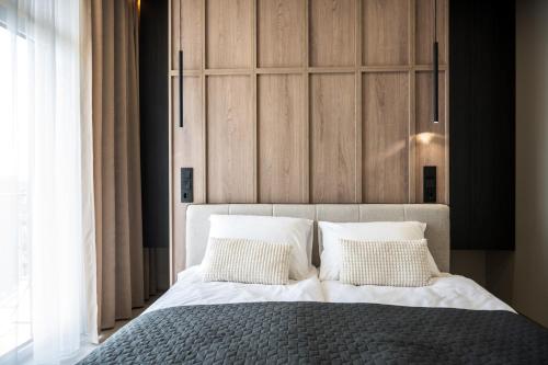 a bedroom with a large bed with white pillows at Luxury Apartments BUDAPEST 2 in Uzhhorod