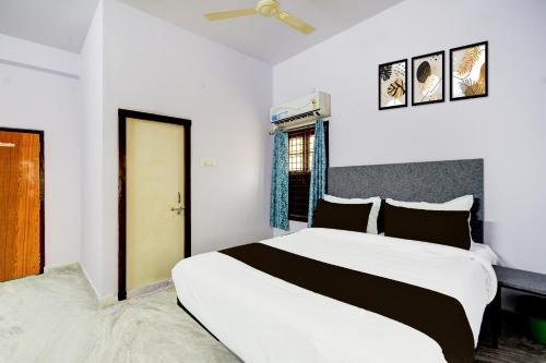 a bedroom with a large white bed and a window at Hotel O Green leaf inn in Surūrnagar