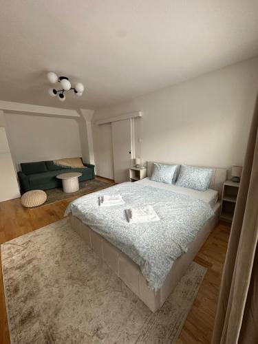 a bedroom with a large bed and a couch at Vyskoč na hory in Nová Lesná