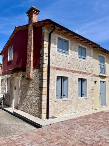 a brick building with windows on a street at Villavecchia in Castegnero