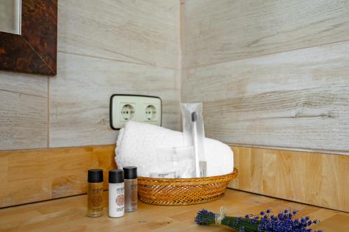 a basket of towels sitting on a table with a lightswitch at Apartamentos San Roque en Llanes by megustarural in Llanes