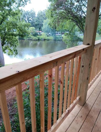 a wooden deck with a view of a lake at Camper only 2 Min to the Lake! in Nancy