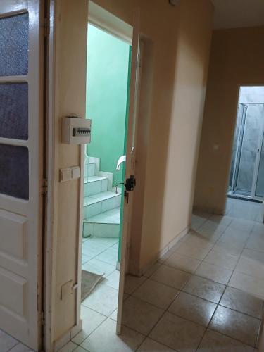 a room with a door and a hallway with stairs at Mar&Cruz in Mindelo