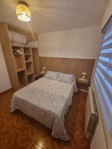 a small bedroom with a bed in a room at A Telleira in Rosal