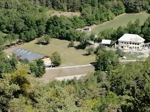 an aerial view of a building in the middle of a forest at Gîtes à La Ferme Du Marquisat in Crots