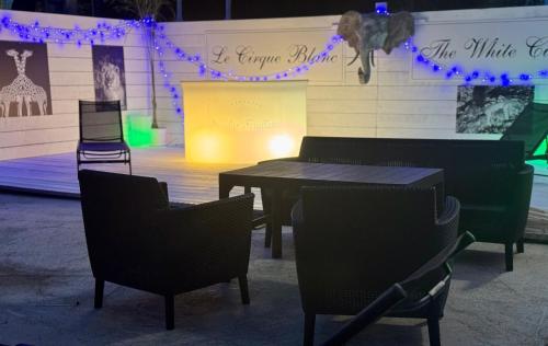 a table and chairs in front of a stage with lights at Maison avec piscine in Antibes