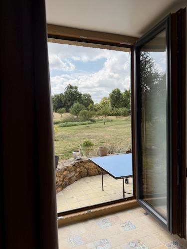 a view of a table from a glass window at Le logis d'Edwige in Le Tallud