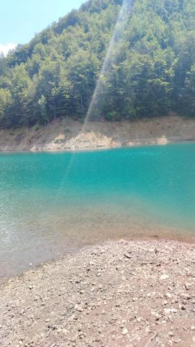 a stream of water spraying into a lake at Brvnara Iva in Jezdići