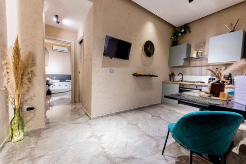 a kitchen with a table and a blue chair at Falco Boutique Home with Jacuzzi in Naples
